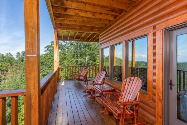 Gliding chairs on the porch at Four Seasons Palace, a 5-bedroom cabin rental located in Pigeon Forge