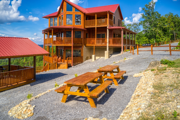 Two picnic tables outside at Four Seasons Palace, a 5-bedroom cabin rental located in Pigeon Forge