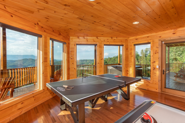 Ping pong table in a game room at Four Seasons Palace, a 5-bedroom cabin rental located in Pigeon Forge