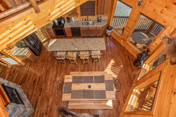 Looking down into the dining space for 12 people at Four Seasons Palace, a 5-bedroom cabin rental located in Pigeon Forge
