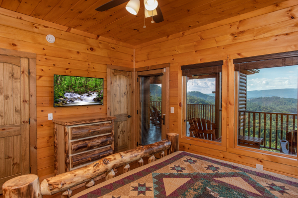 Bedroom with a dresser, TV, deck access, and mountain views at Four Seasons Palace, a 5-bedroom cabin rental located in Pigeon Forge