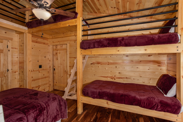 Bunk room with multiple beds at Paws on the Porch, a 2 bedroom cabin rental located in Gatlinburg