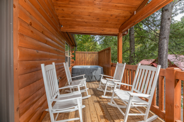 Covered porch with rocking chairs at Paws on the Porch, a 2 bedroom rental cabin in Gatlinburg
