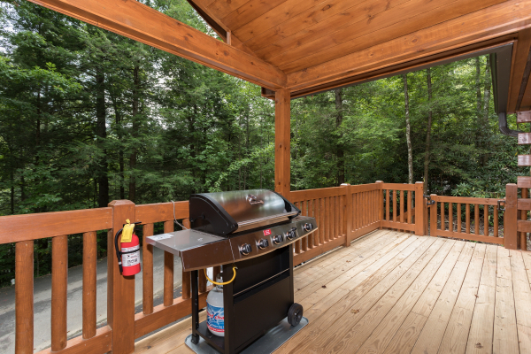 Propane grill on a covered deck at Paws on the Porch, a 2 bedroom cabin rental located in Gatlinburg