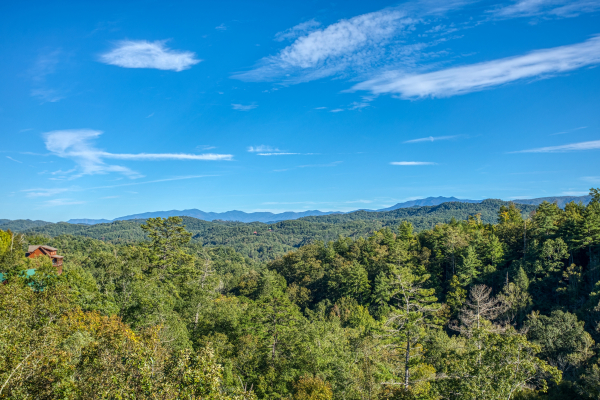 Treetops and mountains viewed from the deck at Great View Lodge, a 5-bedroom cabin rental located in Pigeon Forge