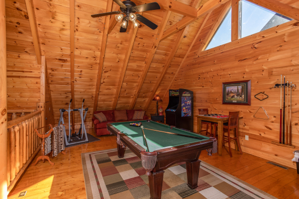 Green felted pool table in the loft at Bears Eye View, a 2-bedroom cabin rental located in Pigeon Forge