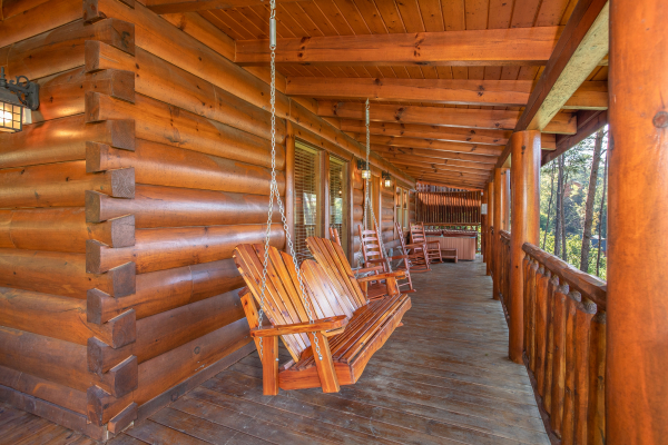 Porch swing on a covered deck at Bears Eye View, a 2-bedroom cabin rental located in Pigeon Forge