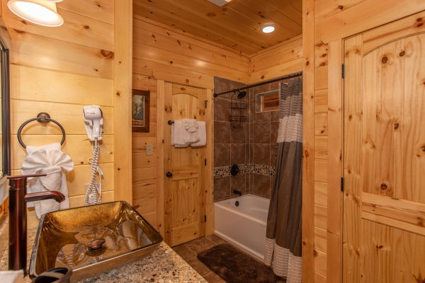 Tub and shower in a bathroom with a custom vanity at Panorama, a 2 bedroom cabin rental located in Pigeon Forge