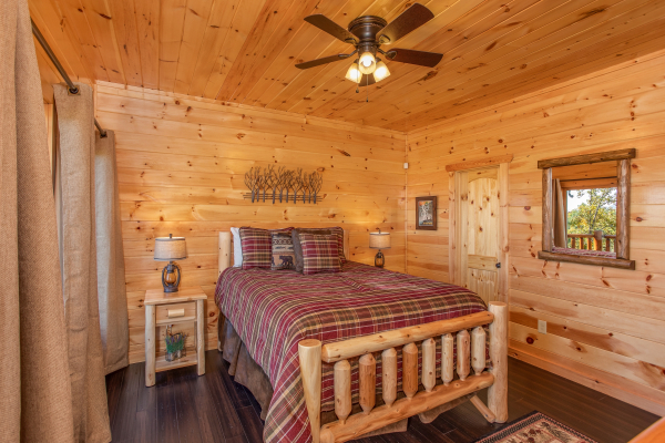 Bedroom with a log bed and two end tables at Panorama, a 2 bedroom cabin rental located in Pigeon Forge