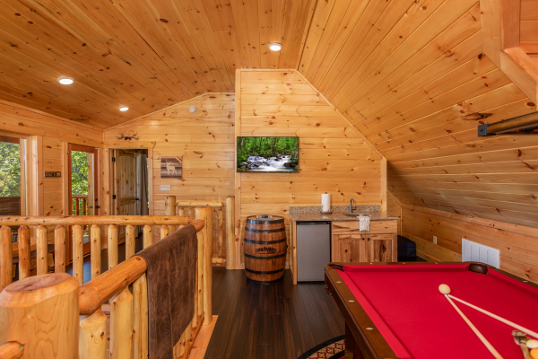 Mini wet bar, TV, and pool table in the loft at Panorama, a 2 bedroom cabin rental located in Pigeon Forge