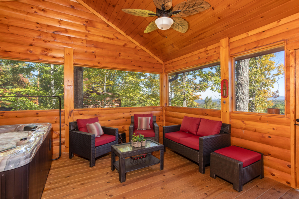 Seating area on the screened in porch at Panorama, a 2 bedroom cabin rental located in Pigeon Forge