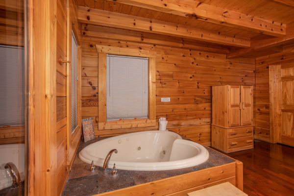 Heart-shaped jacuzzi in the bedroom at Enchanted Evening, a 1-bedroom cabin rental located in Pigeon Forge