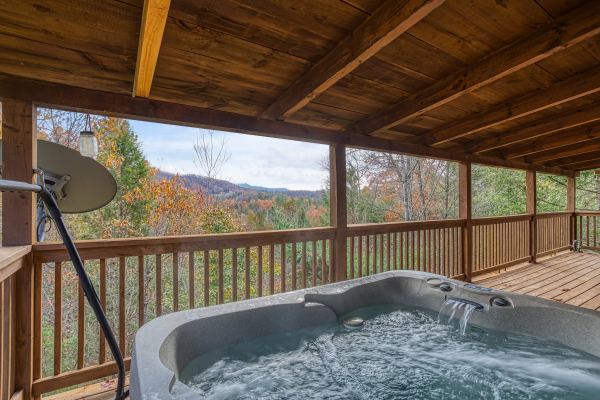 Views of the Smoky Mountains from the hot tub on the covered deck at Enchanted Evening, a 1-bedroom cabin rental located in Pigeon Forge
