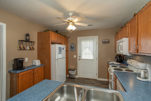 White appliances in a kitchen at Peace at the River, a 3 bedroom cabin rental located in Pigeon Forge