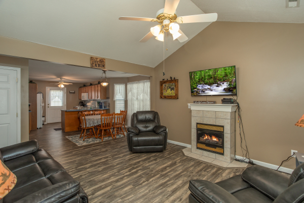 Living, dining, and kitchen space on the main floor at Peace at the River, a 3 bedroom cabin rental located in Pigeon Forge