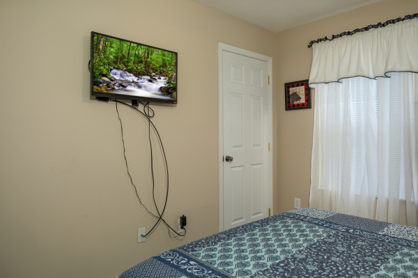 TV in a bedroom at Peace at the River, a 3 bedroom cabin rental located in Pigeon Forge