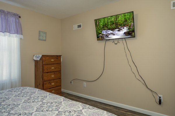 TV in a bedroom at Peace at the River, a 3 bedroom cabin rental located in Pigeon Forge