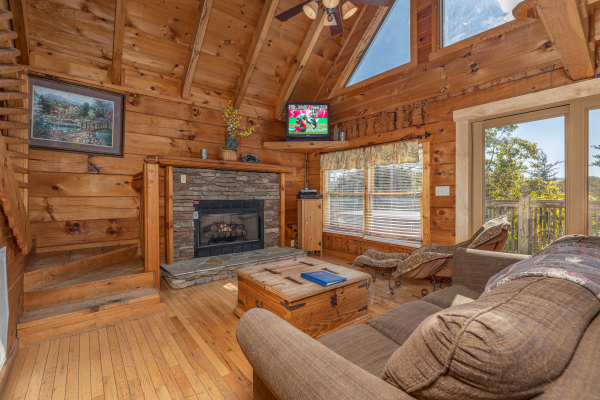 Living room with fireplace and TV at American Beauty, a 2 bedroom cabin rental located in Pigeon Forge