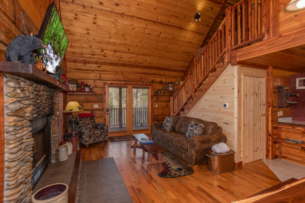 Sofa and chair in the living room at Moonshiner's Ridge, a 1-bedroom cabin rental located in Pigeon Forge
