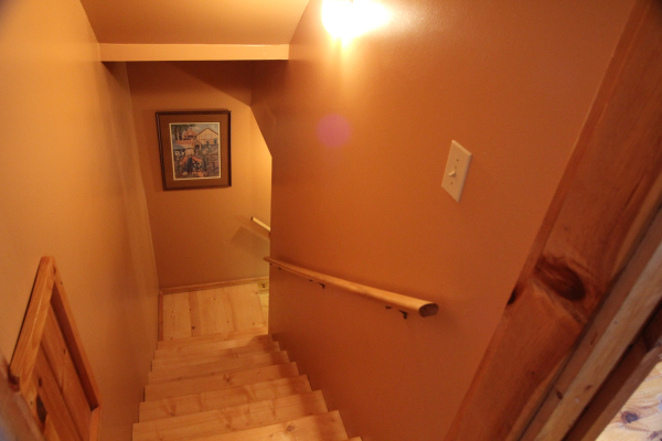 Heading down to the lower level from the main floor at Granny D's, a 2 bedroom cabin rental located in Pigeon Forge