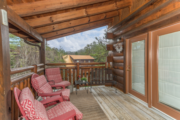 Seating on the covered deck at Granny D's, a 2 bedroom cabin rental located in Pigeon Forge