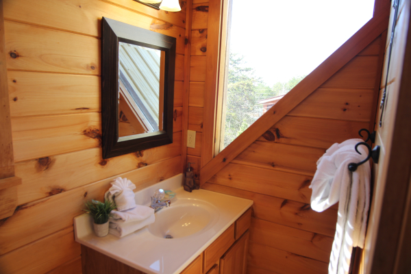 Vanity and large window in the loft bathroom at Granny D's, a 2 bedroom cabin rental located in Pigeon Forge