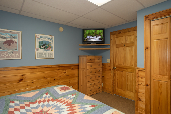 Dresser and TV in the lower floor bedroom at Granny D's, a 2 bedroom cabin rental located in Pigeon Forge