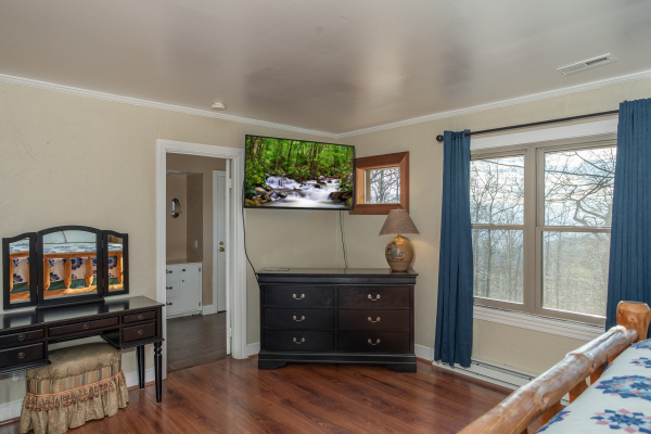 Dresser, TV, and vanity in a bedroom at Best View Ever! A 5 bedroom cabin rental in Pigeon Forge