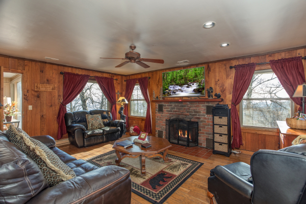 Fireplace and TV in the main living room at Best View Ever! A 5 bedroom cabin rental in Pigeon Forge