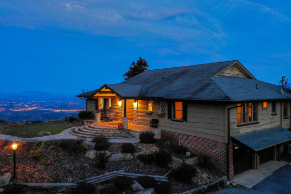 The cabin and city lights at twilight at Best View Ever! A 5 bedroom cabin rental located in Pigeon Forge
