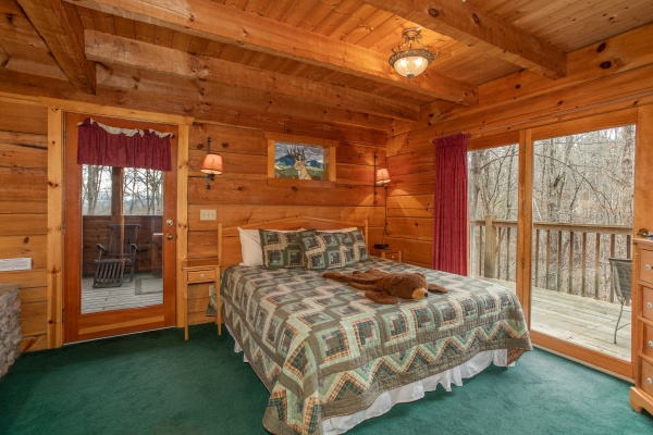 Bedroom with king bed and deck access at Sweet Mountain Escape, a 2 bedroom cabin rental located in Pigeon Forge