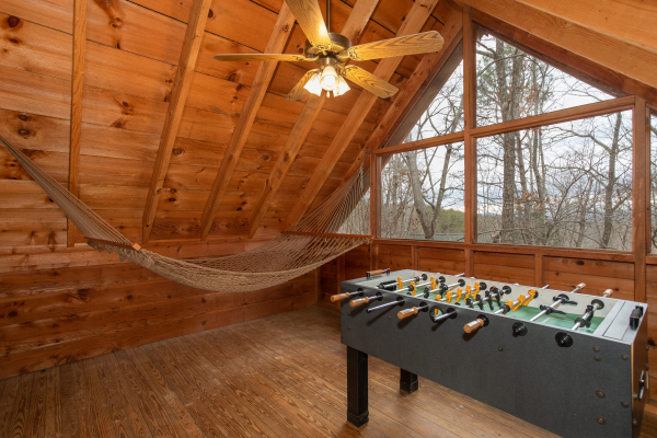 Hammock and foosball in the game loft at Sweet Mountain Escape, a 2 bedroom cabin rental located in Pigeon Forge