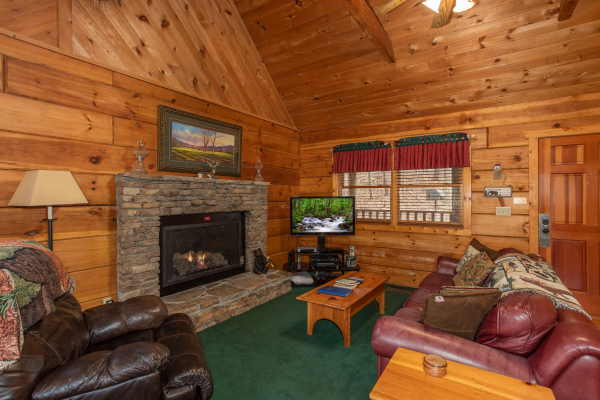 Living room with fireplace and TV at Sweet Mountain Escape, a 2 bedroom cabin rental located in Pigeon Forge