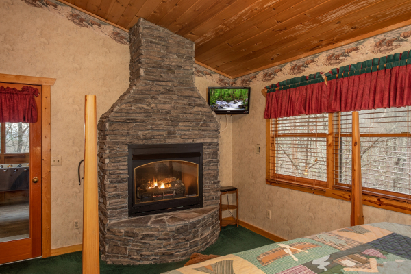 Fireplace and TV in the upper bedroom at Sweet Mountain Escape, a 2 bedroom cabin rental located in Pigeon Forge
