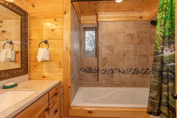 Shower and jacuzzi in a bathroom at Happy Bear's Hideaway, a 2 bedroom cabin rental located in Gatlinburg
