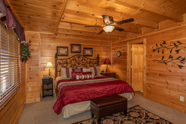 Bedroom with a king bed and en suite bath at Better View, a 4 bedroom cabin rental located in Pigeon Forge