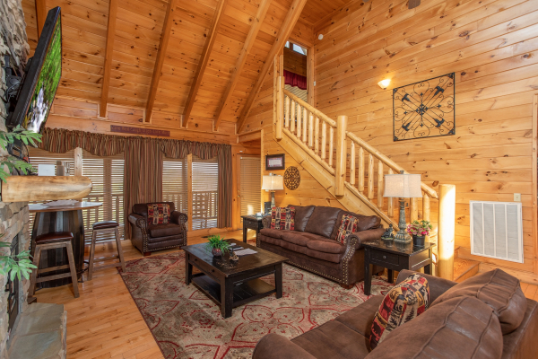 Queen sleeper sofa and additional seating in the living room at Better View, a 4 bedroom cabin rental located in Pigeon Forge