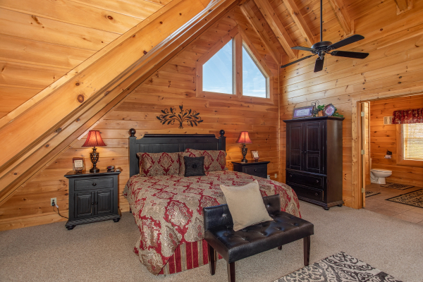 King bed with two nights stands and an armoire in the loft at Better View, a 4 bedroom cabin rental located in Pigeon Forge