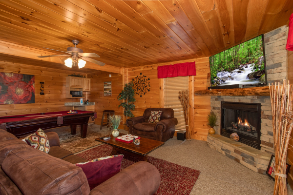 Lower level second living room with fireplace and TV at Better View, a 4 bedroom cabin rental located in Pigeon Forge