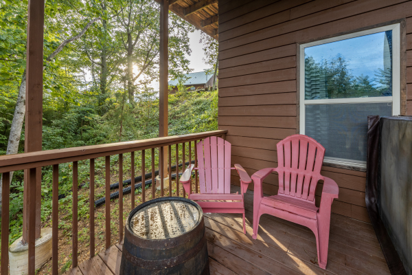 Red Adirondack chairs on the lower deck at Bearing Views, a 3 bedroom cabin rental located in Pigeon Forge