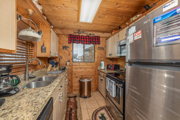 Galley kitchen with stainless appliances at Bearing Views, a 3 bedroom cabin rental located in Pigeon Forge