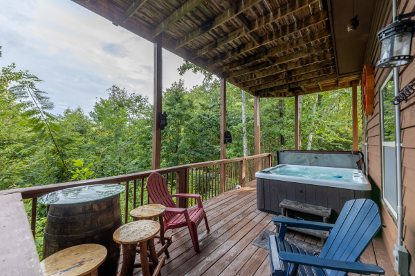 Lower deck with seating and a hot tub at Bearing Views, a 3 bedroom cabin rental located in Pigeon Forge