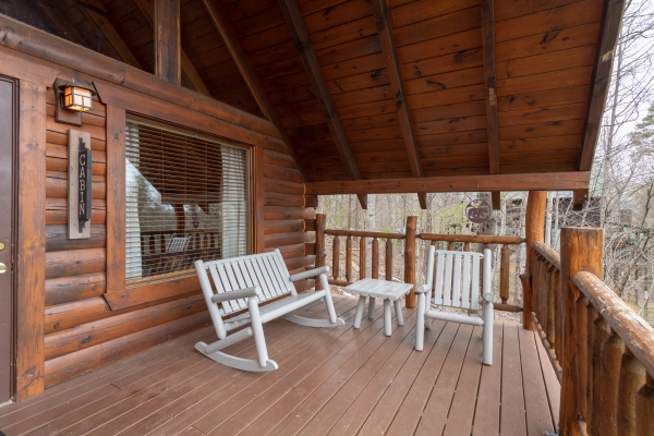 Front porch with rocking chair and bench at Woodland Chalet, a 1 bedroom cabin rental located in Pigeon Forge