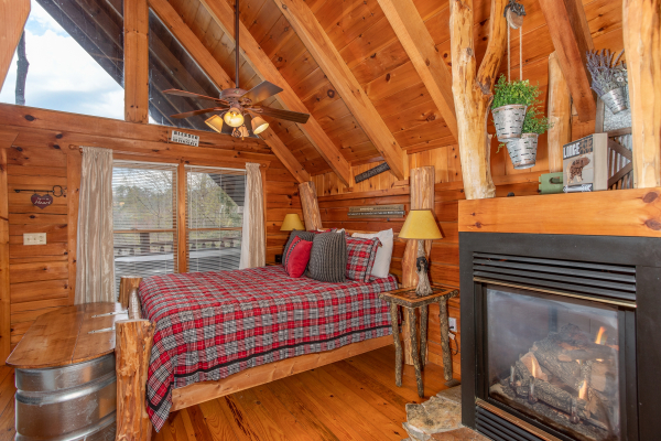 Fireplace in the bedroom at Woodland Chalet, a 1 bedroom cabin rental located in Pigeon Forge