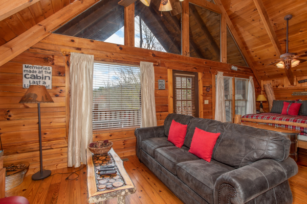 Living room with sofa at Woodland Chalet, a 1 bedroom cabin rental located in Pigeon Forge