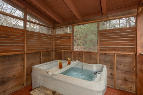 Hot Tub under covered deck at The Nest, a 1 bedroom cabin rental located in pigeon forge