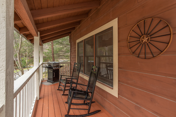 Rocking Chairs on covered porch at The Nest, a 1 bedroom cabin rental located in pigeon forge