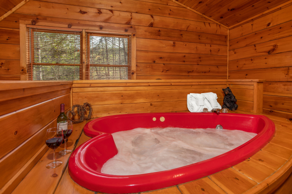 Heart shaped Jacuzzi at The Nest, a 1 bedroom cabin rental located in pigeon forge
