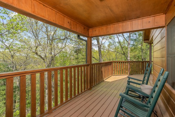 Rocking chairs on the covered porch at Hillside Haven, a 1 bedroom cabin rental located in Pigeon Forge