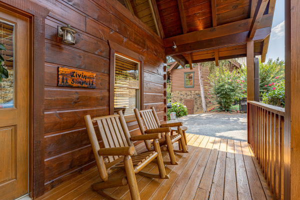 Covered deck seating at Livin' Simple, a 2 bedroom cabin rental located in Pigeon Forge